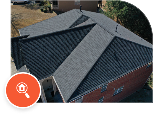 Aerial view of modern residential home with dark gray asphalt shingle roof